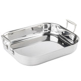 A tri-ply stainless steel roasting pan with rounded edges and two sturdy, riveted handles. The shiny, reflective surface enhances its elegance as it rests empty on a plain white background.