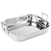 A tri-ply stainless steel roasting pan with rounded edges and two sturdy, riveted handles. The shiny, reflective surface enhances its elegance as it rests empty on a plain white background.