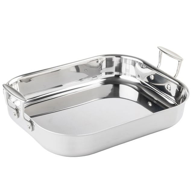 A tri-ply stainless steel roasting pan with rounded edges and two sturdy, riveted handles. The shiny, reflective surface enhances its elegance as it rests empty on a plain white background.