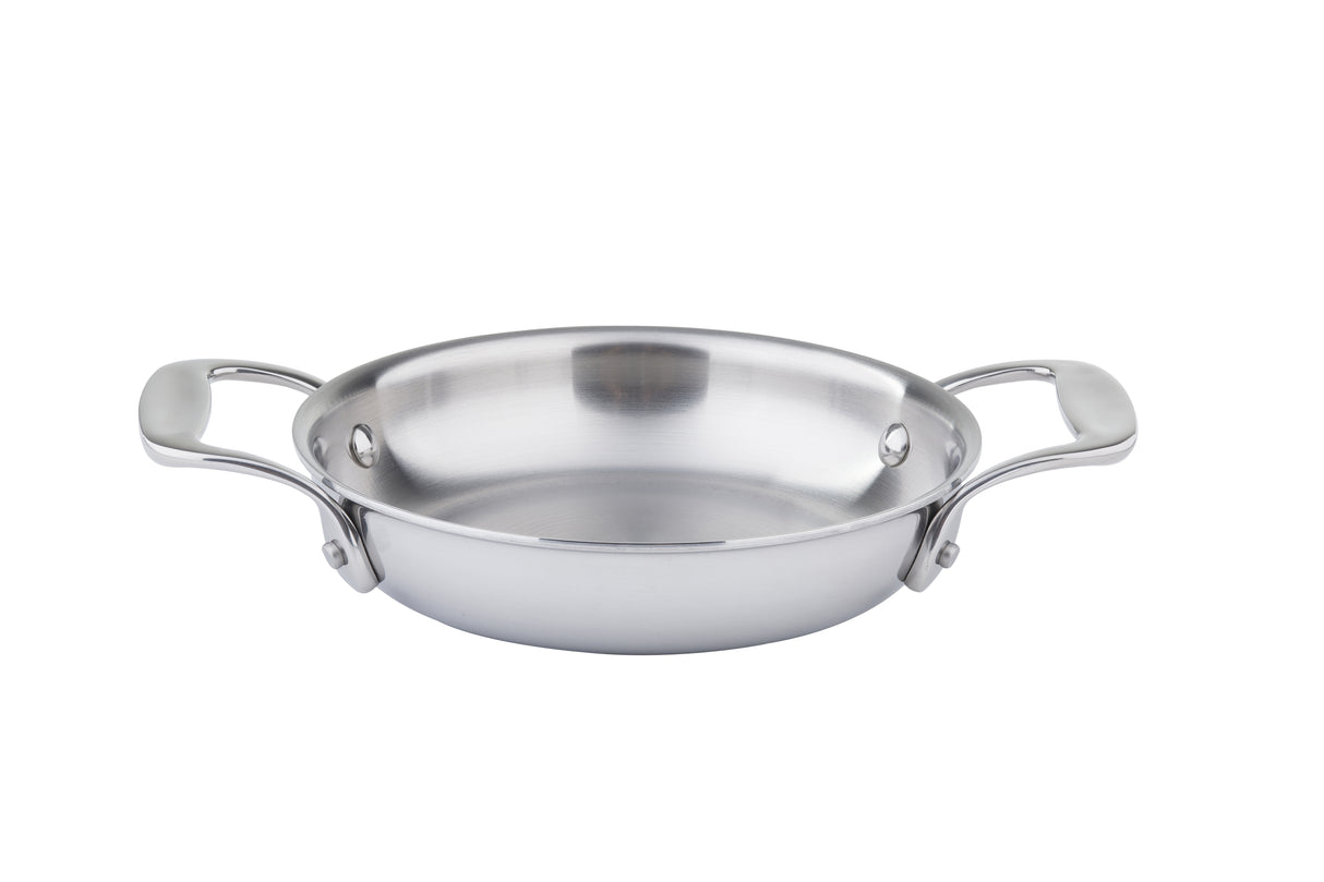 A shiny stainless steel casserole pan with two wide handles sits on a white background. Shallow with a smooth interior, this tri-ply casserole features a brushed metal finish for modern appeal and even heating.