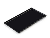 A rectangular, flat black cast aluminum tray with raised edges and a smooth surface, designed as a cooling plate serving tray, photographed on a white background and angled slightly to show its depth and clean lines.