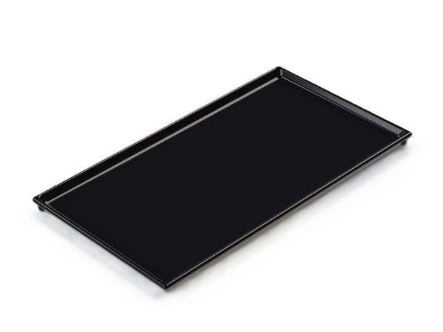 A rectangular, flat black cast aluminum tray with raised edges and a smooth surface, designed as a cooling plate serving tray, photographed on a white background and angled slightly to show its depth and clean lines.