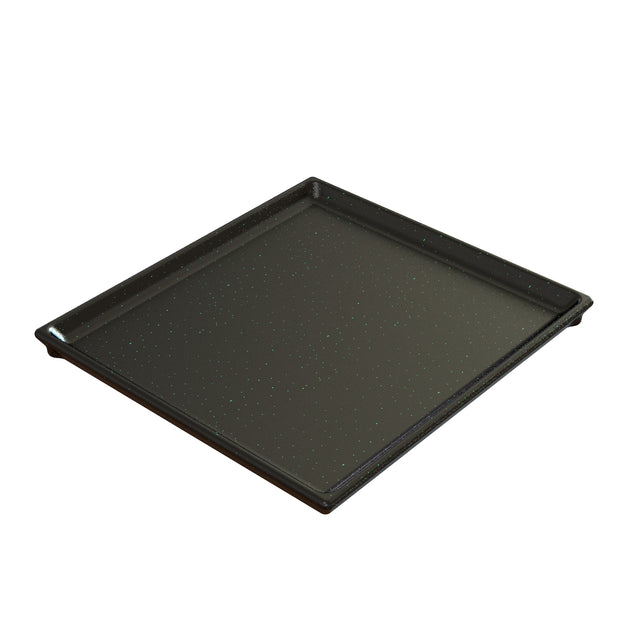 A square, black cast aluminum baking tray with slightly raised edges and a smooth surface with small white speckles, shown on a white background. The tray is empty and angled slightly to the right.