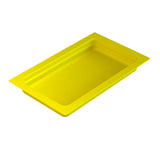 A rectangular, bright yellow food pan with slightly rounded inner corners and a smooth surface, viewed at an angle from above, shows depth and a flat rim. The tray is empty and placed on a white background.