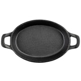 A black oval cast iron skillet, similar to a Mini Au Gratin Server, with two short handles on opposite sides, is shown from above on a white background. The skillet has a rough, textured surface and raised edges for non-stick cooking.