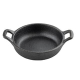 A round, black cast iron TableCraft Mini Server skillet with a rough texture and two handles on opposite sides sits on a white background. The skillet is empty and features a slightly raised edge around the rim.