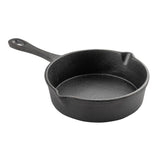 A black cast iron mini skillet by TableCraft, featuring a short handle with a hanging hole, round shape, dual pouring spouts, and a textured surface for a sturdy, rustic look. The background is plain white.
