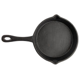 A round, black TableCraft cast iron skillet with a long handle and two small pouring spouts, photographed from above on a white background. The mini skillet has a slightly textured surface and a hole at the end of the handle for hanging.