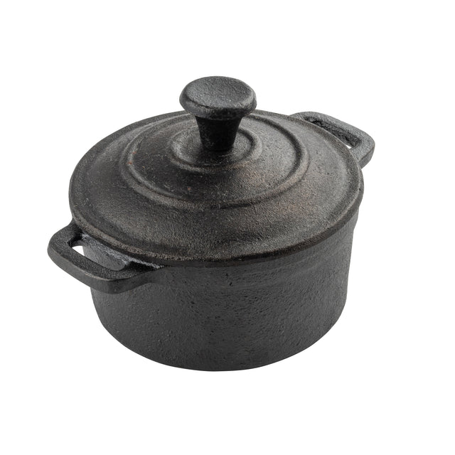 A round, black TableCraft cast iron pot with a matching lid and two side handles sits on a white background. The mini casserole dish has a textured, matte finish and a prominent knob on the lid for easy lifting.