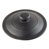 A round, black cast iron mini casserole lid by TableCraft with a central knob handle. The lid features a slightly raised, concentric circular design and textured surface, giving it a rugged, matte appearance. Photographed on a white background.