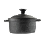 A black cast iron Dutch oven with a textured surface and matching lid, featuring short handles and a round knob on top, resembles a mini casserole dish by TableCraft, shown against a white background.
