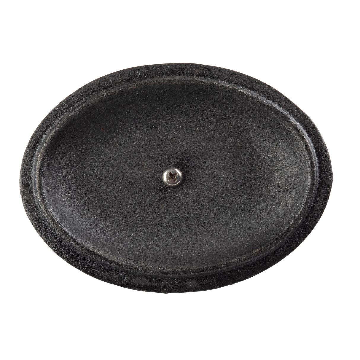 A black, oval-shaped, textured cast iron object resembling a shallow dish or tray is shown from above. A single silver screw is positioned in the center. The surface appears smooth in the middle, with a slightly raised, rough edge.