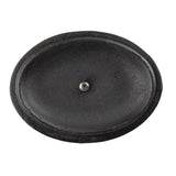 A black, oval-shaped, textured cast iron object resembling a shallow dish or tray is shown from above. A single silver screw is positioned in the center. The surface appears smooth in the middle, with a slightly raised, rough edge.