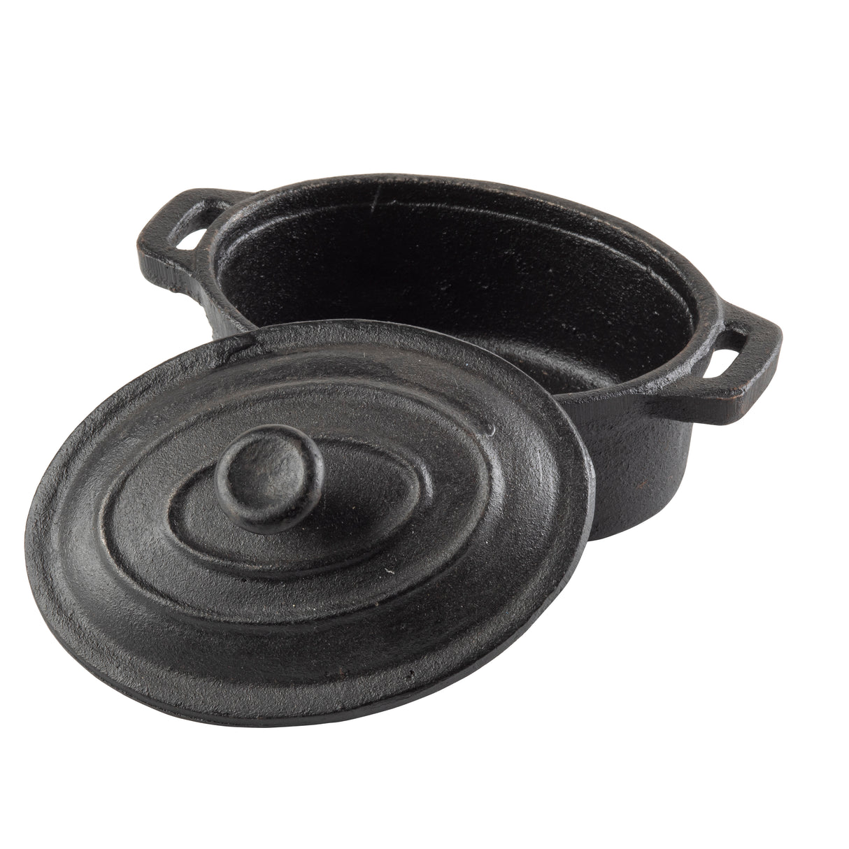 A black TableCraft cast iron oval dutch oven with two handles and a matching lid. The lid is slightly tilted off, resting against the pot, revealing the empty interior. The surface features a matte, textured finish.