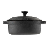 A black cast iron Dutch oven with a matching lid, shown from the side. The pot has sturdy handles, a rough textured surface, and a knob on the lid for easy lifting. This TableCraft mini casserole dish is set against a plain white background.