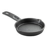 A small, round TableCraft mini skillet made of black cast iron with a textured surface, a short handle featuring a hole for hanging, and two pour spouts on opposite sides. The skillet is empty and shown on a white background.