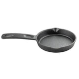 A small, round TableCraft mini skillet with a textured cast iron surface, a wide handle featuring a hole for hanging, and two pour spouts on opposite sides. The empty pan rests on a plain white background.