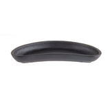 A black, oval-shaped TableCraft server with curved sides and a smooth matte finish sits centered against a plain white background. The shallow dish appears to be made of ceramic or cast iron.