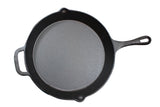 A black pre-seasoned cast iron skillet with a long handle and a small assist handle is shown from above on a white background. The empty skillet features a smooth, matte surface.