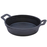 A round, black TableCraft cast iron pan with two sturdy handles on opposite sides. The pan has high sides, a flat base, and a matte finish, giving this mini server a rustic and durable appearance.