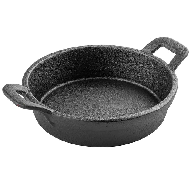A round, black TableCraft cast iron skillet with thick sides, textured surface, and two looped handles sits empty on a plain white background. This sturdy mini server is perfect for stovetop or oven cooking.