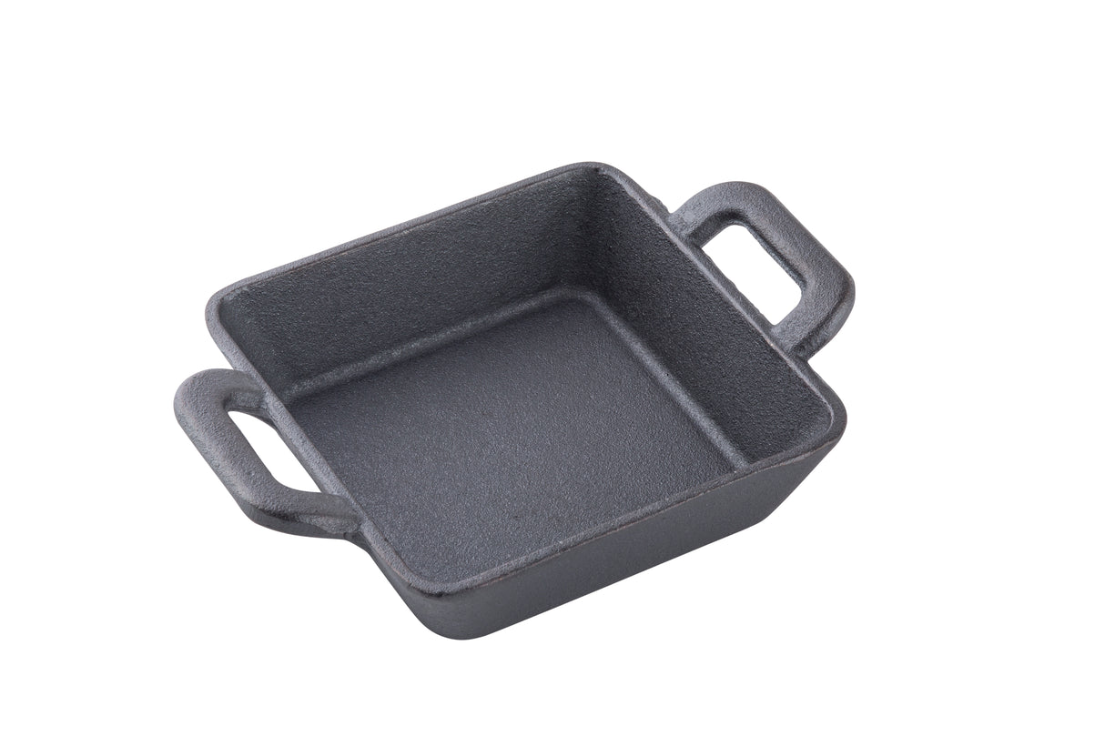 A small, square TableCraft CW30150 mini cast iron server with two short handles sits on a white background. The empty square mini server features a slightly textured black surface and classic cast iron design.