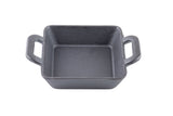 A square black cast iron baking dish with two handles, viewed from above on a white background. This TableCraft mini server features a textured surface and no lid, perfect for stylish tabletop presentations.