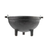 A black cast iron Mini Kettle Server by TableCraft features a rounded body, three sturdy legs, and side handles. Its rough texture and lidless design make it perfect for outdoor cooking or camping against a plain white background.