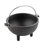 A black cast iron mini kettle server with three short legs and a rounded body, featuring a metal handle arching above the rim. The empty TableCraft pot is displayed against a plain white background.