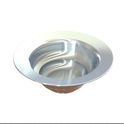 A shiny, metallic, circular cast aluminum sink with gently curving lines on the interior surface. The wide, flat rim and deep bowl reflect light on its smooth surface, evoking the look of a cold holding salad bowl against a plain white background.