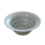 A plain, round, shallow white salad bowl with smooth sides, a wide rim, and a glossy surface, ideal for cold holding and set against a plain white background.