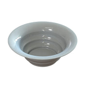 A plain, round, shallow white salad bowl with smooth sides, a wide rim, and a glossy surface, ideal for cold holding and set against a plain white background.