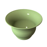 A glossy, light green Tulip Salad Bowl with a wide, flared rim and rounded base is shown against a white background. Its smooth ceramic surface reflects light, emphasizing its shiny, unadorned finish and simple, elegant design.