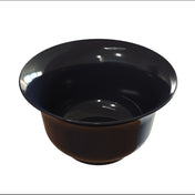 A shiny, black, round cold holding bowl with a wide rim and smooth surface, shown empty and viewed from above at an angle against a plain white background.