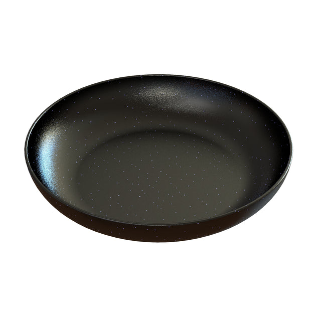 A round, shallow Pasta Bowl with a smooth, matte black finish and tiny white speckles covers its surface like a starry night sky. Crafted from cast aluminum, it’s photographed against a white background.