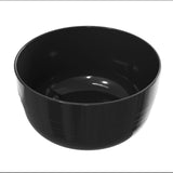 A glossy, empty black cast aluminum bowl with a smooth surface and slight horizontal ridges near its base is shown against a plain white background. The bowl is round, deep, and has a shiny, reflective finish.