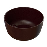 A plain, round, dark brown fruit bowl with a matte finish and slightly textured surface, viewed from an angle above and to the side, set against a white background. The interior and exterior of the bowl are uniformly colored.