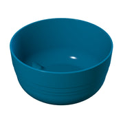 A plain, round, deep blue plastic fruit bowl with a smooth surface and subtle horizontal ridges near the base, shown on a white background. The bowl is empty, and a small highlight reflects off the inner surface.