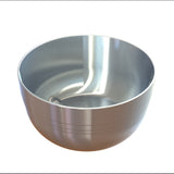 A shiny, metallic cast aluminum bowl with a smooth, reflective surface and faint horizontal lines near the base sits empty on a white background. The interior has a unique, curved indentation and a glossy finish. Perfect as an elegant fruit bowl.