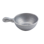 A small, round, gray cast aluminum soup bowl with a short, thick handle on one side. The surface is rough and unpolished, giving it a rustic, handmade appearance. The empty bowl is positioned against a plain white background.