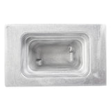 A rectangular, metallic food pan with smooth, rounded inner edges and two raised bumps inside. The brushed cast aluminum surface is shiny, featuring a recessed central cavity and a flat, thick border. Image captured from a top-down angle.