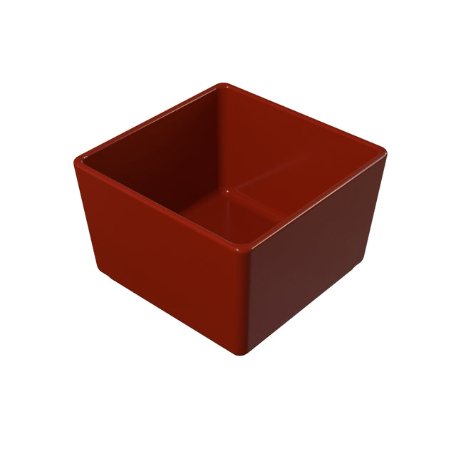A glossy, square-shaped, deep red cast aluminum bowl with straight sides and rounded edges sits on a white background. The bowl appears empty and boasts a simple, modern design that is both stylish and dishwasher safe.