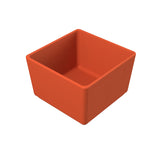 A small, square, orange ceramic dish with smooth, straight sides and a glossy finish. The dish is empty and sits on a white background, viewed at an angle showing its depth—ideal as a dishwasher safe bowl for everyday use.