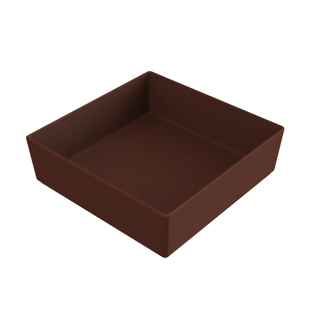 A plain, empty, square baking pan with high sides, shown at an angle. The brown pan, possibly cast aluminum or coated metal, features a smooth finish and sits against a white background.