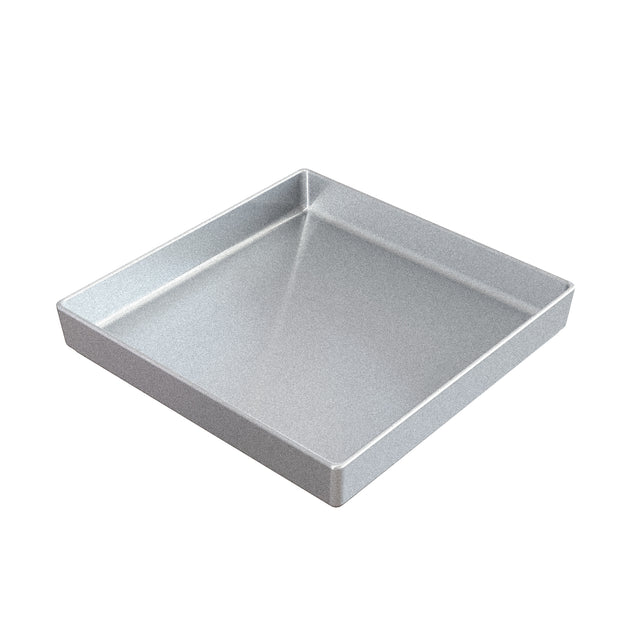 A square, metallic baking pan with straight sides and a smooth, shiny surface is shown on a white background. Crafted similarly to a sand cast aluminum bowl, it features a flat base and rounded edges, ideal for baking cakes or brownies.