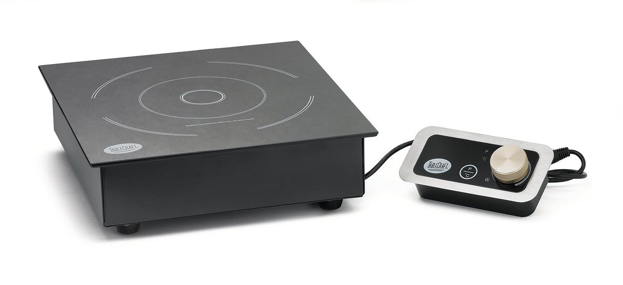 A sleek black single burner induction cooktop with white circular markings is displayed on a countertop. To the right, a separate control panel with a gold knob connects by cable. Both devices rest on a white background.