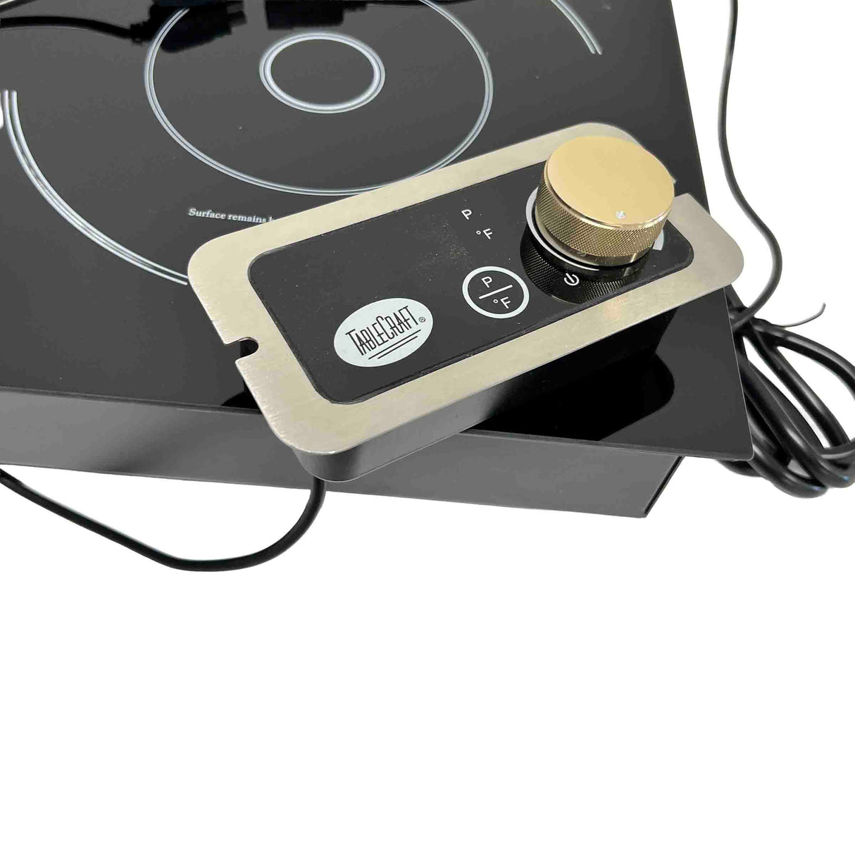 A close-up of a TABLECRAFT single burner induction cooktop for your countertop, featuring a detachable rectangular control panel with a gold knob, P and F buttons, and visible coiled black power cords.