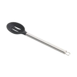 A black slotted silicone spoon with a long, stainless steel handle and a hanging loop at the end. The spoon’s oval head features three slots for draining liquids, making it an ideal serving spoon for everyday kitchen use.