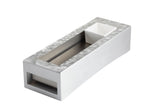 A modern, rectangular metallic object with a slightly textured surface, featuring a recessed channel in the center and a small white square bowl at one end—perfect as a TableCraft cooling station thanks to its open section.