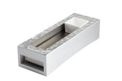 A modern, rectangular metallic object with a slightly textured surface, featuring a recessed channel in the center and a small white square bowl at one end—perfect as a TableCraft cooling station thanks to its open section.